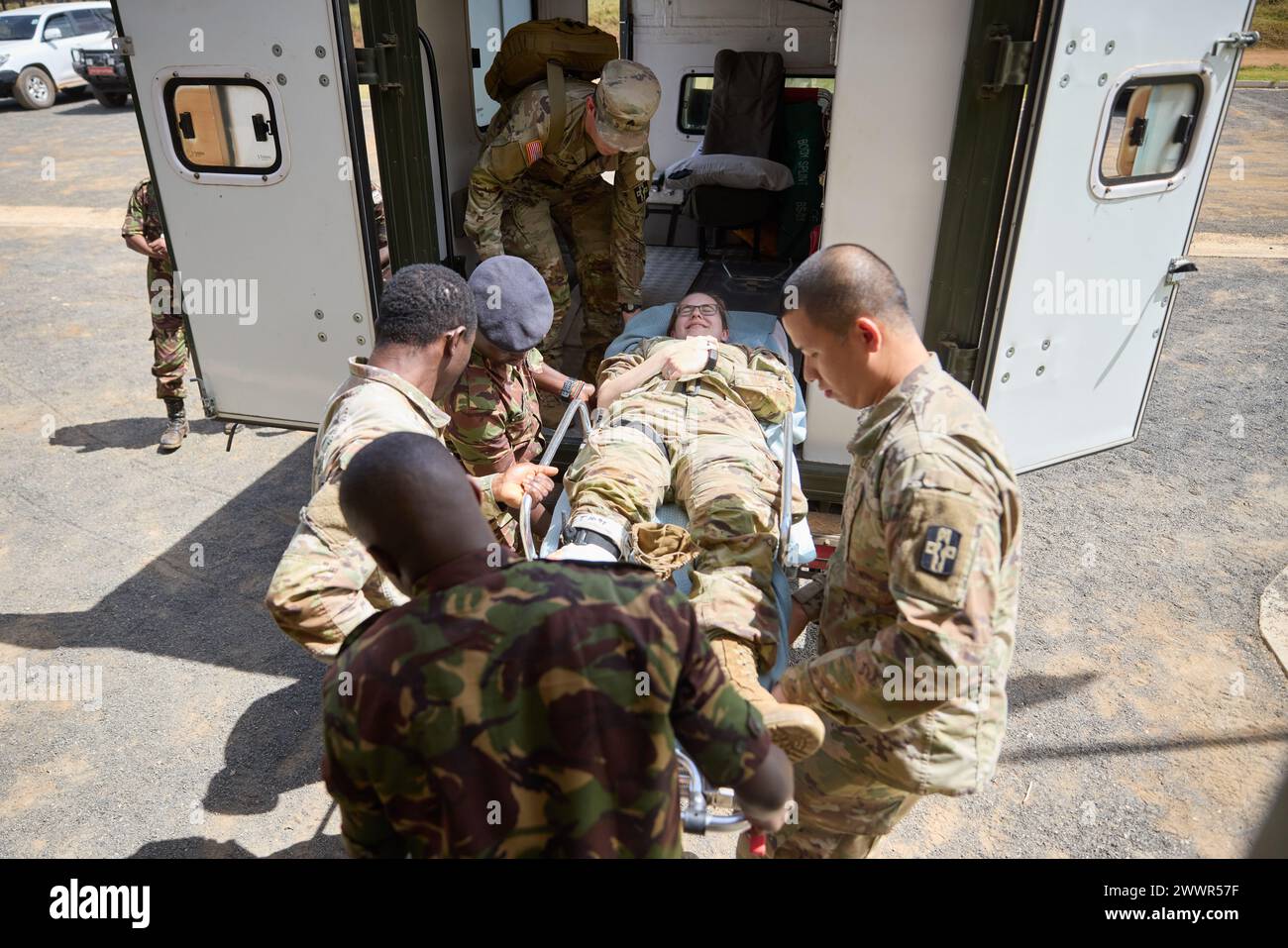 Military members from the Kenya Defence Forces and U.S. Army Soldiers from the 921st Field Hospital, 176th Medical Brigade, 807th Medical Command, a U.S. Army Reserve unit, lift a casualty into an ambulance during a medical evacuation rehearsal during Justified Accord 2024 (JA24) at the Counter Insurgency Terrorism and Stability Operations Training Centre in Nanyuki, Kenya February 27, 2024. JA24 is U.S. Africa Command's largest exercise in East Africa, running from Feb. 26 - March 7. Led by U.S. Army Southern European Task Force, Africa (SETAF-AF), and hosted in Kenya, this year's exercise wi Stock Photo