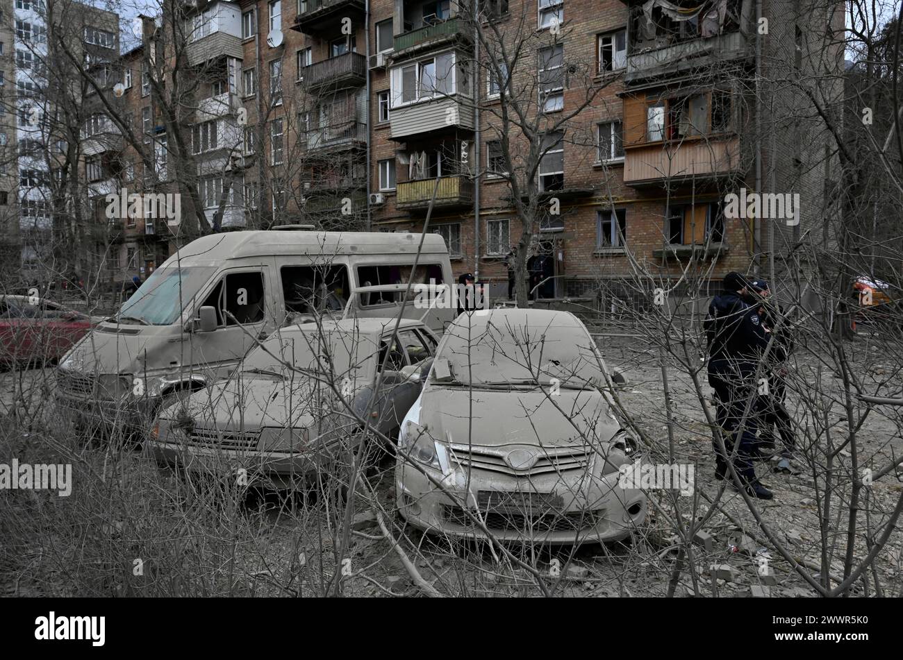 Kyiv, Ukraine. 25th Mar, 2024. Police officers stand near damaged cars that suffered as a result of a missile attack by the Russian army. The Russian army struck missile strike on Kyiv, As a result of the shelling of the capital of Ukraine, 10 people were injured. Credit: SOPA Images Limited/Alamy Live News Stock Photo