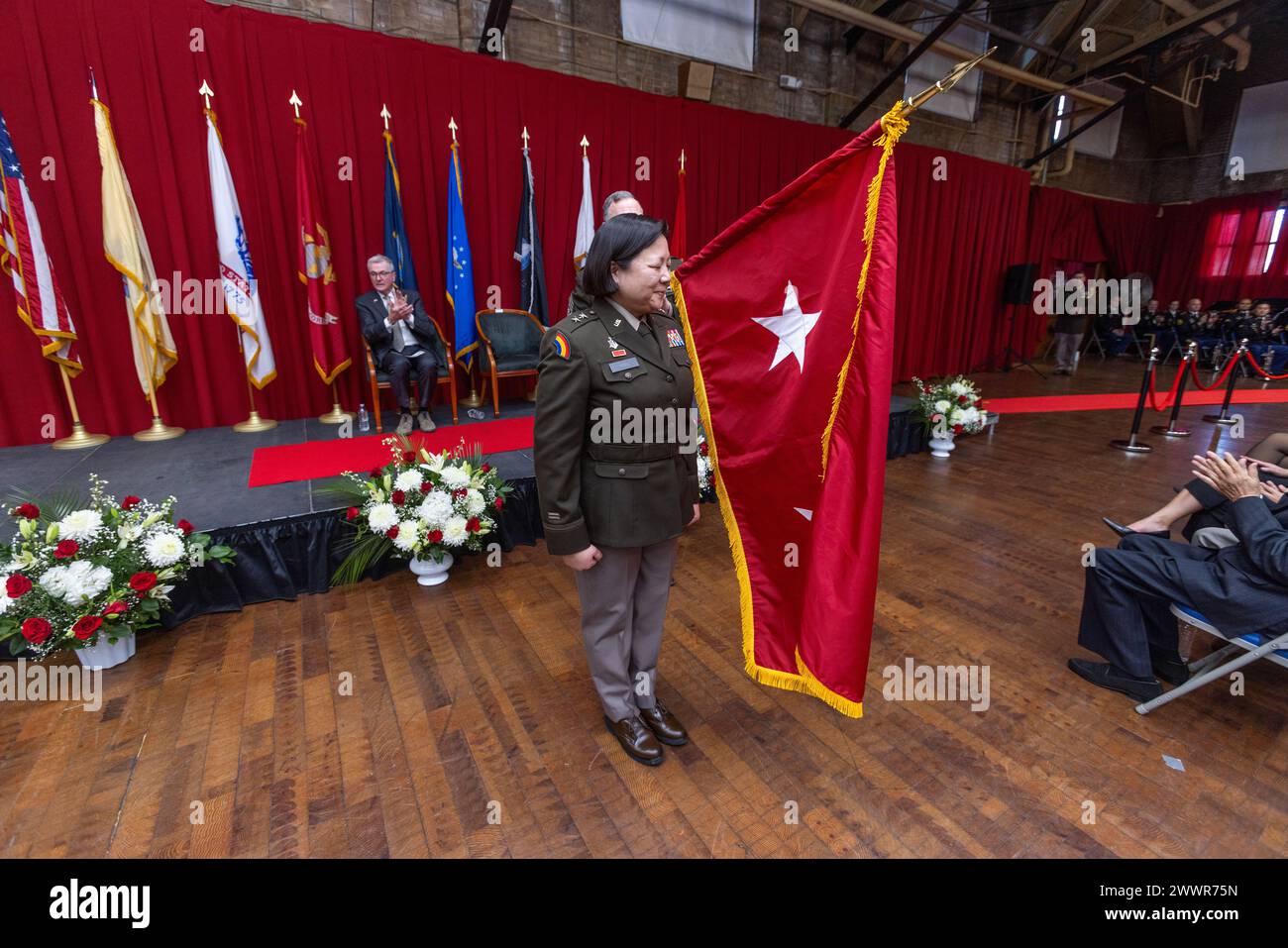 Maj. Gen. Lisa J. Hou, D.O., The Adjutant General of New Jersey, stands next to her two-star general’s flag during her promotion ceremony at National Guard Armory in Lawrenceville, New Jersey, Feb. 3, 2024. Hou, the 33rd Adjutant General of New Jersey, commands more than 8,400 Soldiers and Airmen of the New Jersey National Guard. As Commissioner of the New Jersey Department of Military and Veterans Affairs, Hou leads, directs, and manages the New Jersey Department of Military and Veterans Affairs in the execution of federal and state missions. In addition, she manages all state veterans’ progr Stock Photo