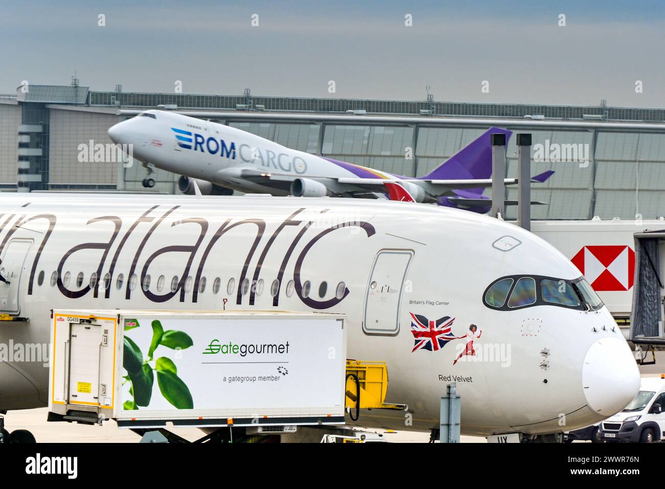 London, England, UK - 30 November 2023: Catering truck loading supplies into a Virgin Atlantic Airways Airbus A350 at London Heathrow airport. Stock Photo