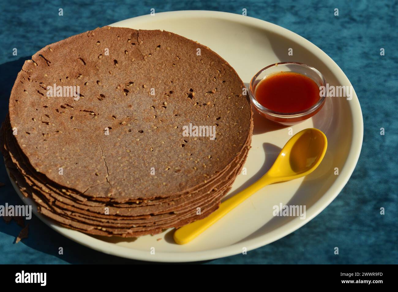Indian Khakhra is a Traditional Gujarati snack also know as khakra, crispy roti or ragi  khakra are thin crackers made from wheat flour,ragi and oil Stock Photo