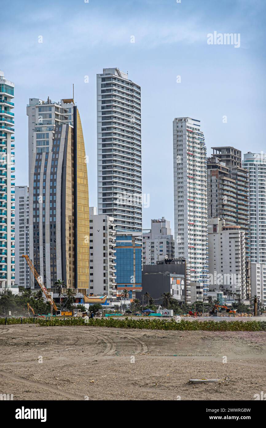 Cartagena, Colombia - July 25, 2023: Bocagrande neighborhood skyline with golden facade of Hotel be life experience Dubai under blue sky. Work on beac Stock Photo