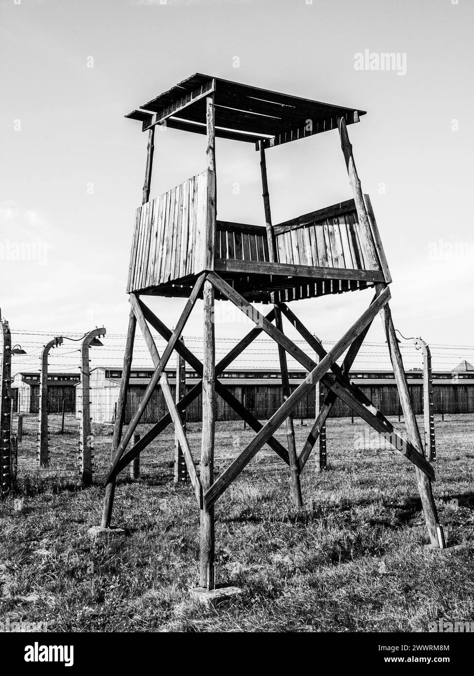Old wooden watch tower in concentration camp Auschwitz - Birkenau, Oswiecim - Brzezinka, Poland, Europe. Black and white image. Stock Photo