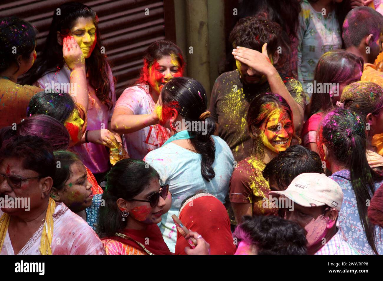 March 25, Kolkata City India: Devotees spread colored powders on themselves to celebrate the Hindu spring festival of Holi outside a temple in Howrah district, near Kolkata on March 25, 2024 in Kolkata City India. (Credit Image: © Dipa Chakraborty/eyepix via ZUMA Press Wire) EDITORIAL USAGE ONLY! Not for Commercial USAGE! Stock Photo