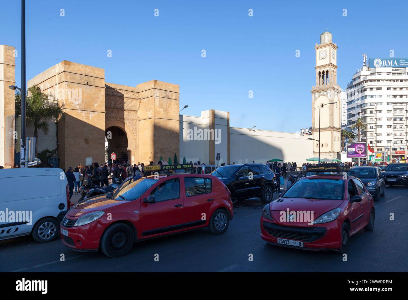 Casablanca, Morocco -  January 17 2019: Two 'Petit Taxi' (Small red taxi operating in some Moroccan cities), near Bab Marrakech and the clock tower of Stock Photo