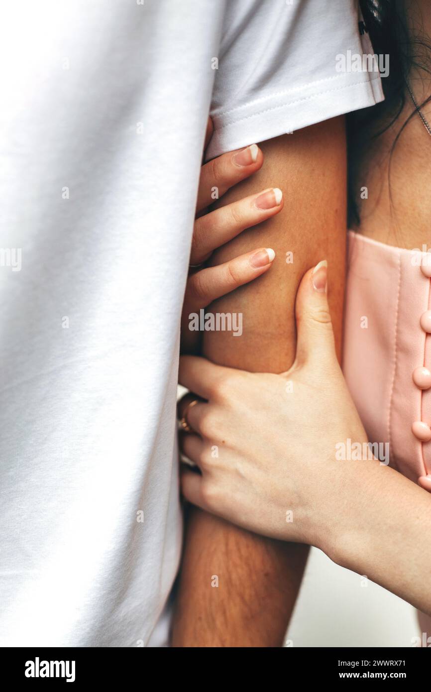 A detailed view of two individuals touching each other in a close and intimate manner. Stock Photo