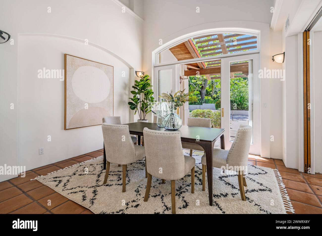 White table in center of room with open patio door Stock Photo Alamy