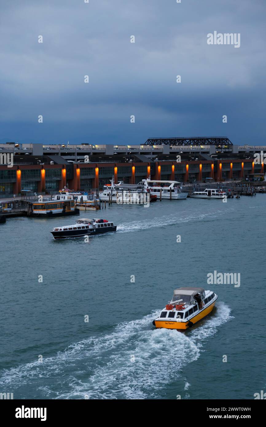 Venice, Italy - October, 6 2019: Vaporetti or Venetian public water buses, or water taxies in Venetian Lagoon at Cruise Port of Venice, cruise ship pa Stock Photo