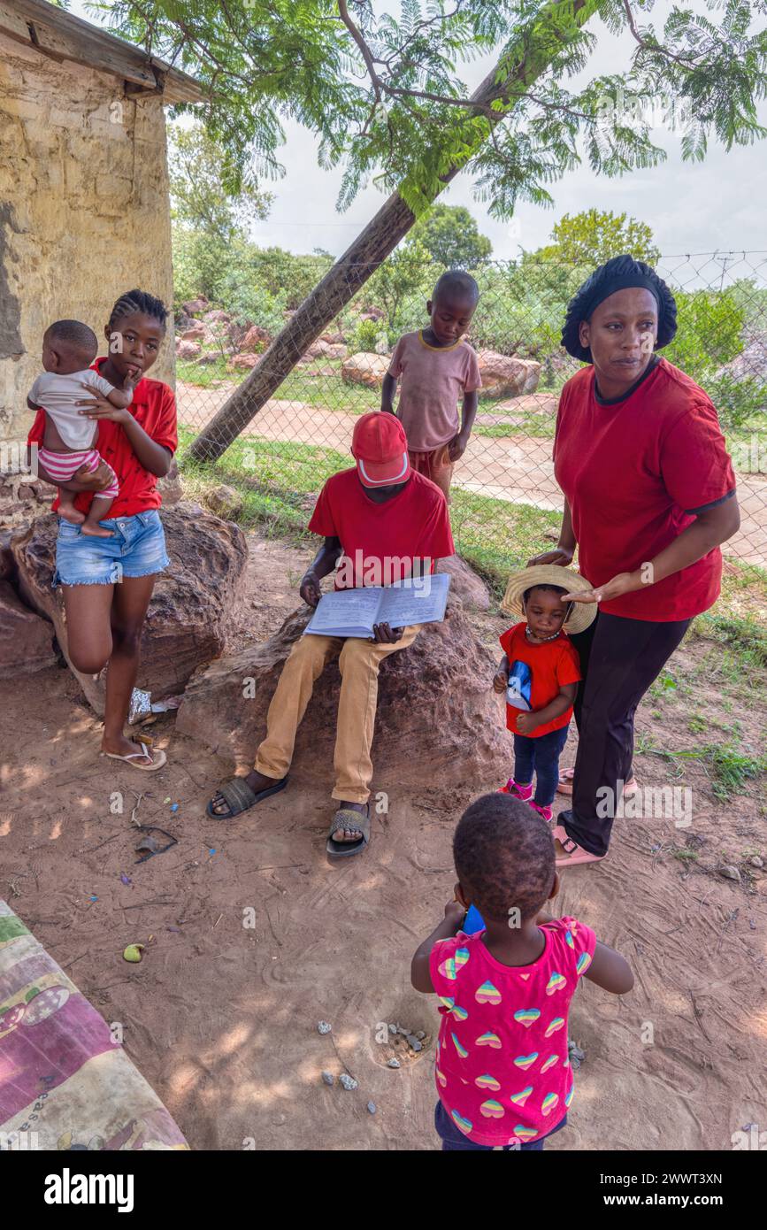 african village life, community education, group of people, outdoors under the shade of the tree Stock Photo