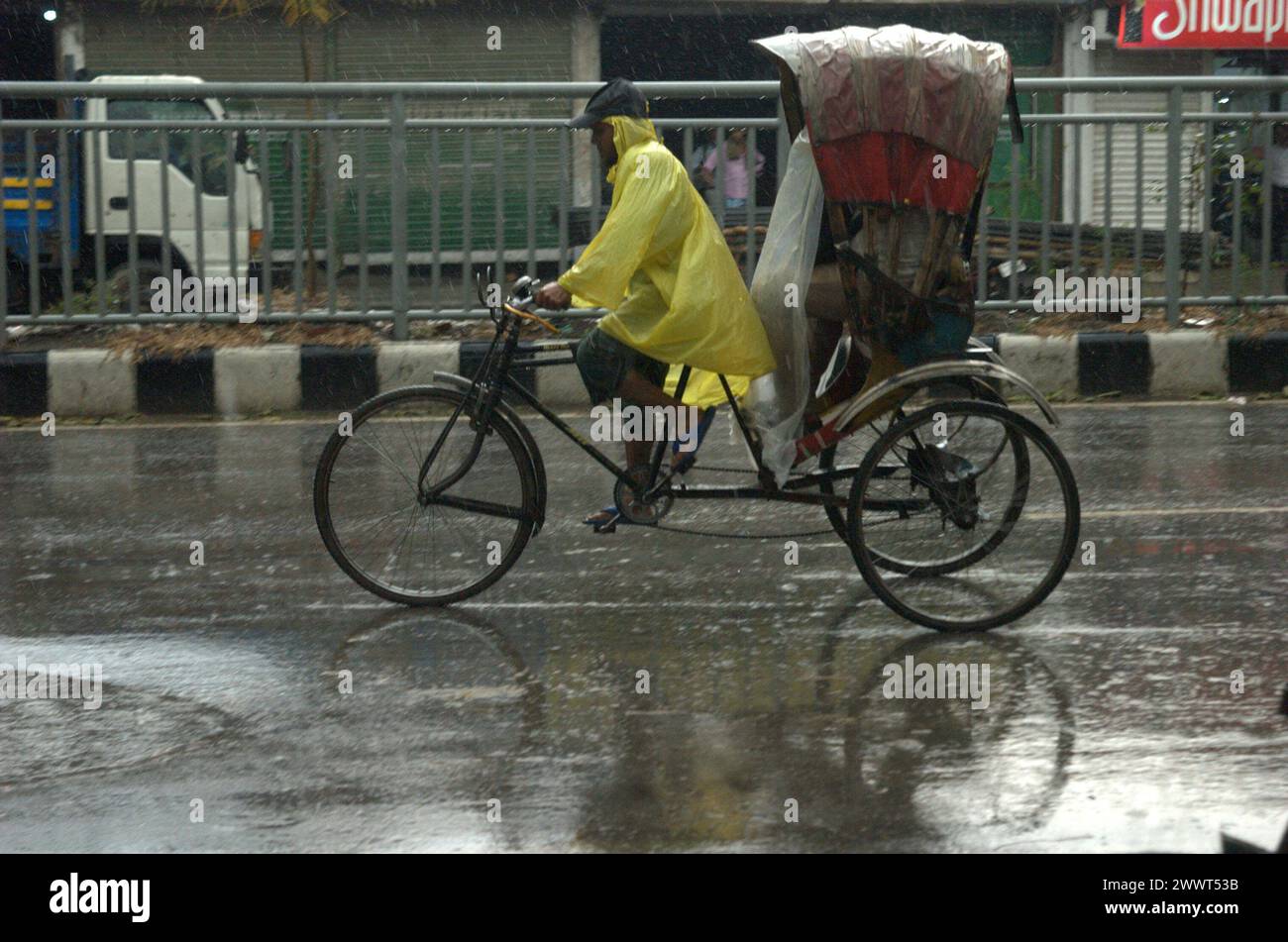 Hasan Reksha Dhaka, Bangladesh. 26th Mar, 2024. A rickshaw puller and a passenger ...
