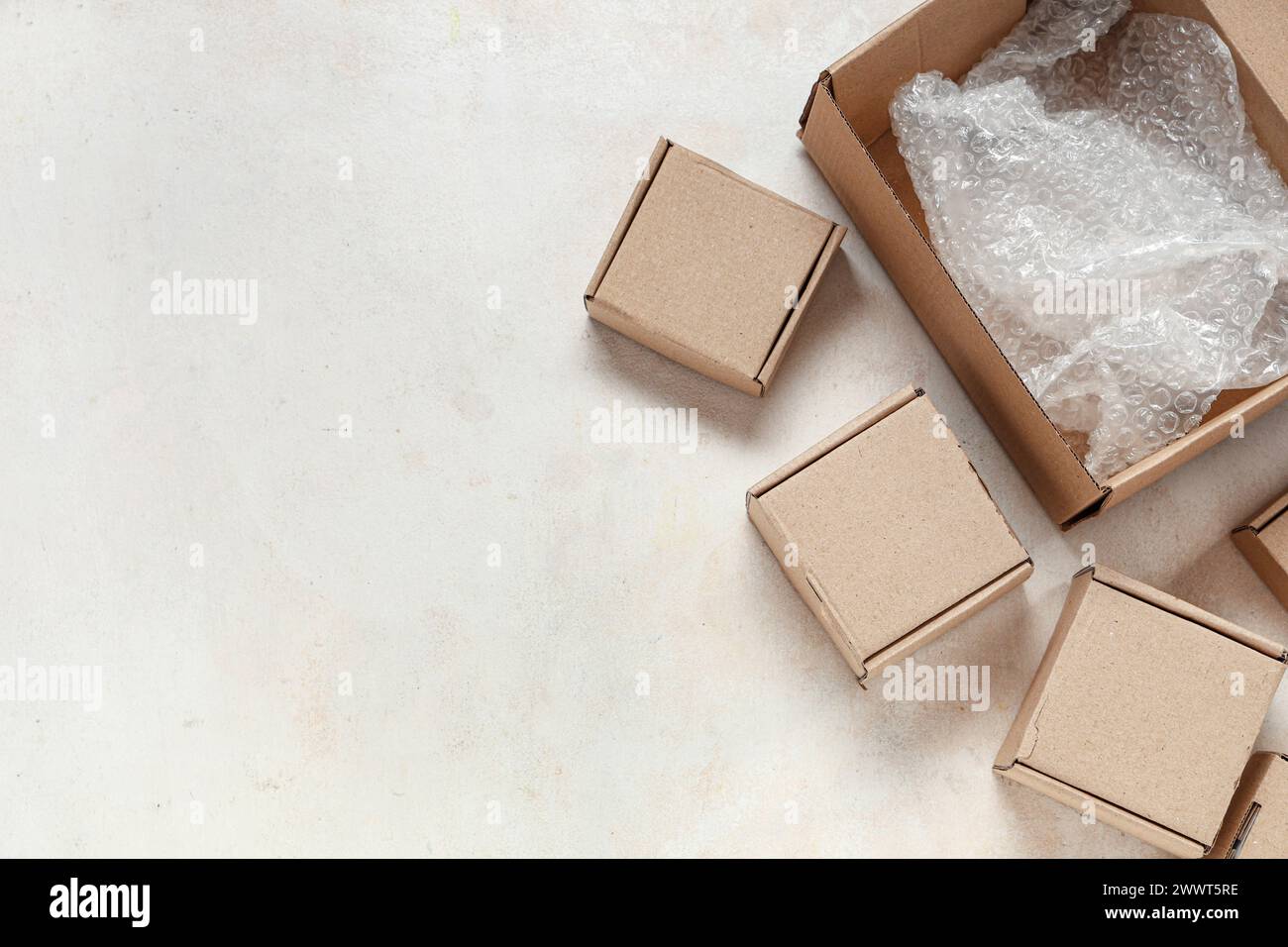 Cardboard packages with bubble wrap on white table Stock Photo
