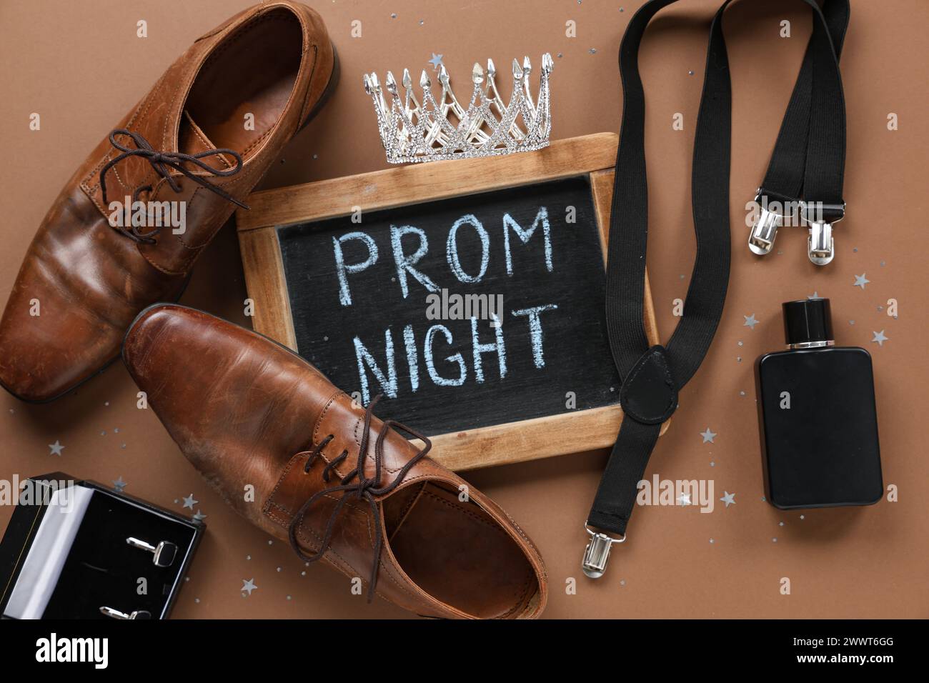 Chalkboard with text PROM NIGHT, male shoes and suspender on brown background Stock Photo