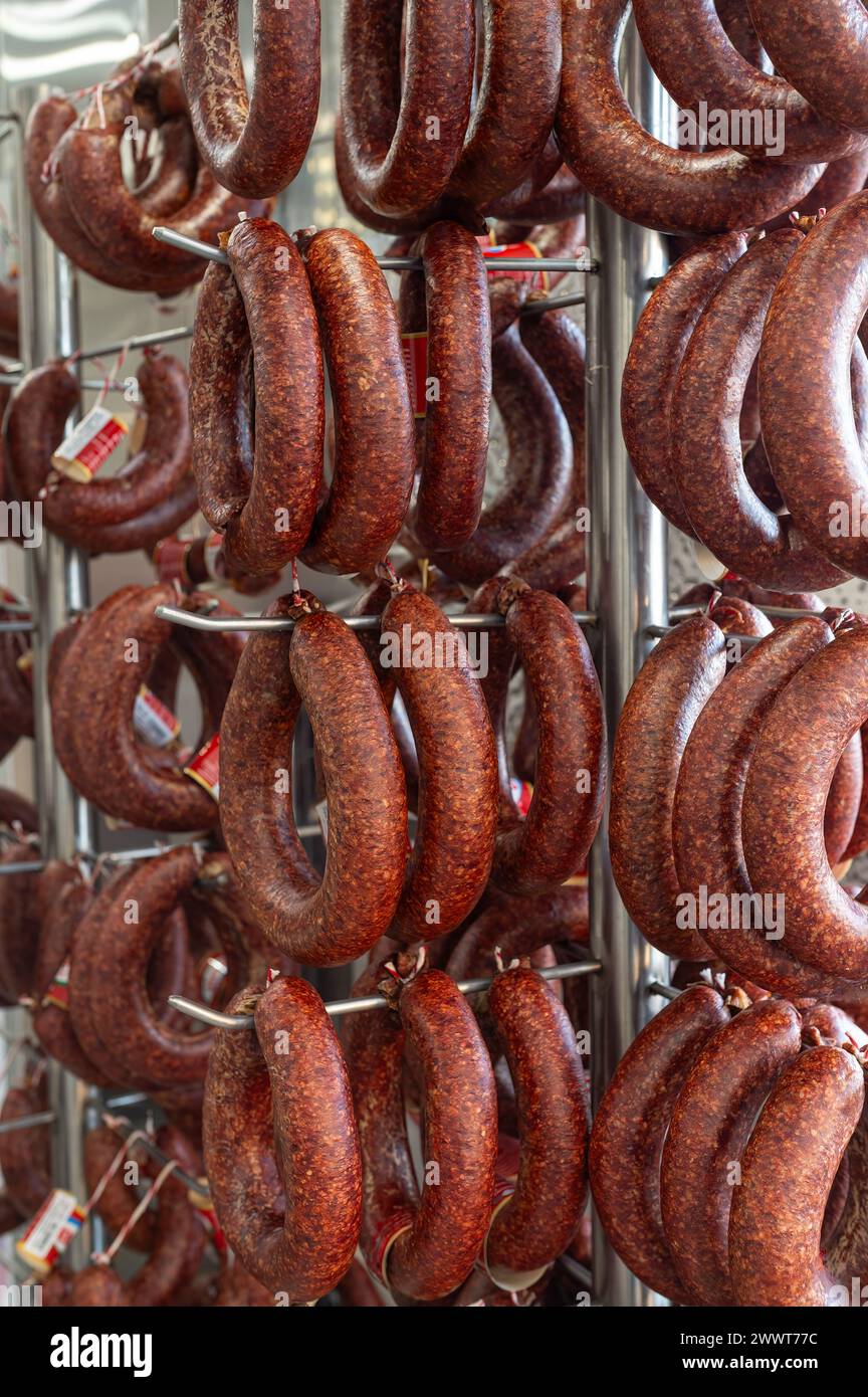 Sausages displayed on the counter for sale in the butcher's shop. Stock Photo