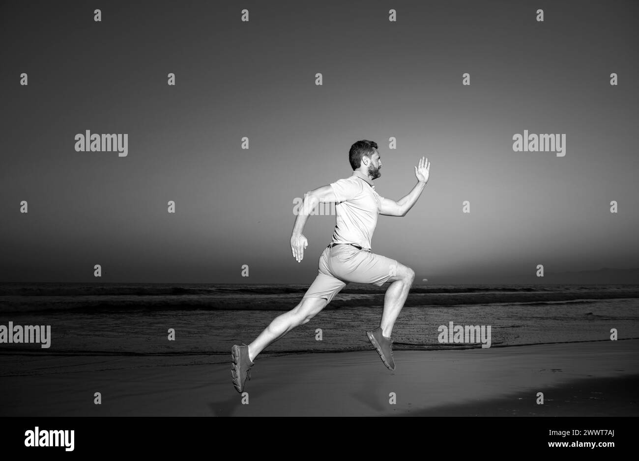 Man running on the beach at sunset. Athletic young man running in the ...