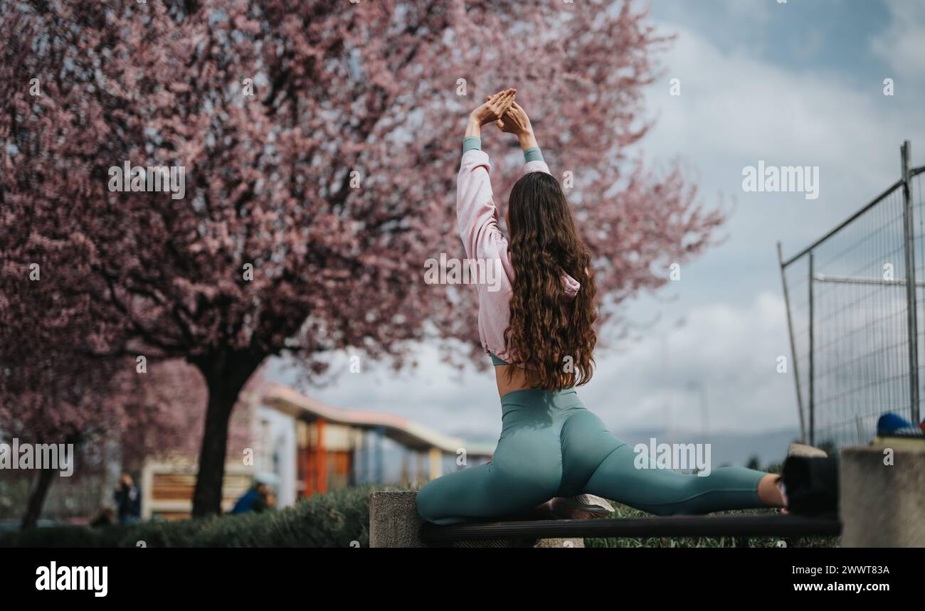 Spring Yoga Pic Woman practicing yoga outdoors in spring with cherry blossoms Stock ...