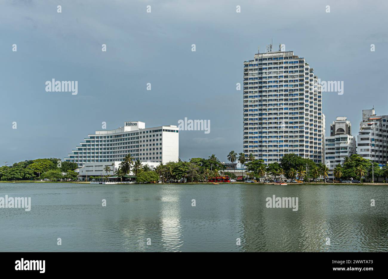 Cartagena, Colombia - July 25, 2023: Central Bocagrande. Hilton hotel on south side of El Laguito laguna with greenish water and other tall apartment Stock Photo