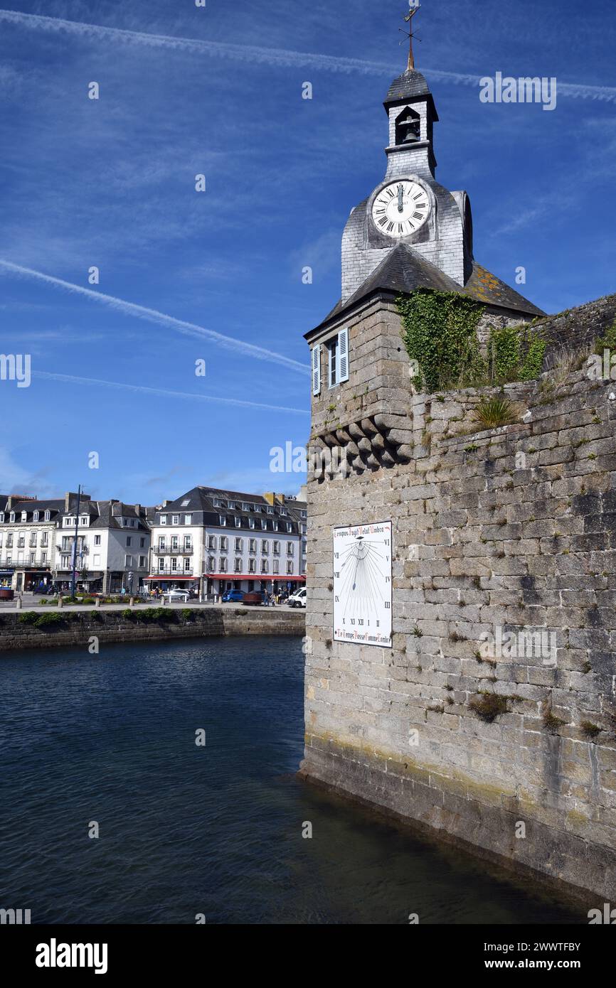 southwest corner of the wall of Ville Close with clock and sundial, restaurant L'Amiral in the background, France, Brittany, Concarneau Stock Photo