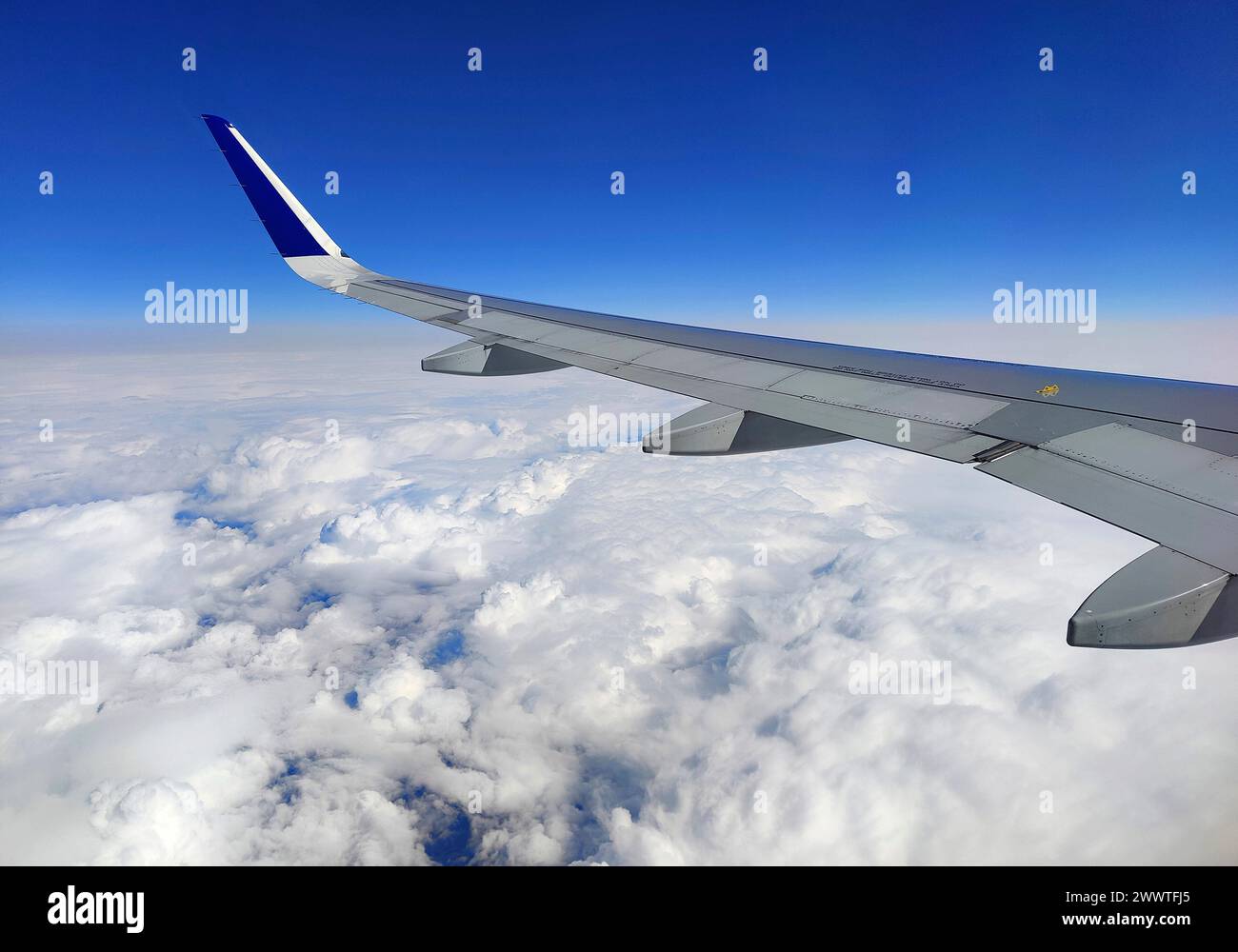 view from the aircraft over the wing to the clouds Stock Photo
