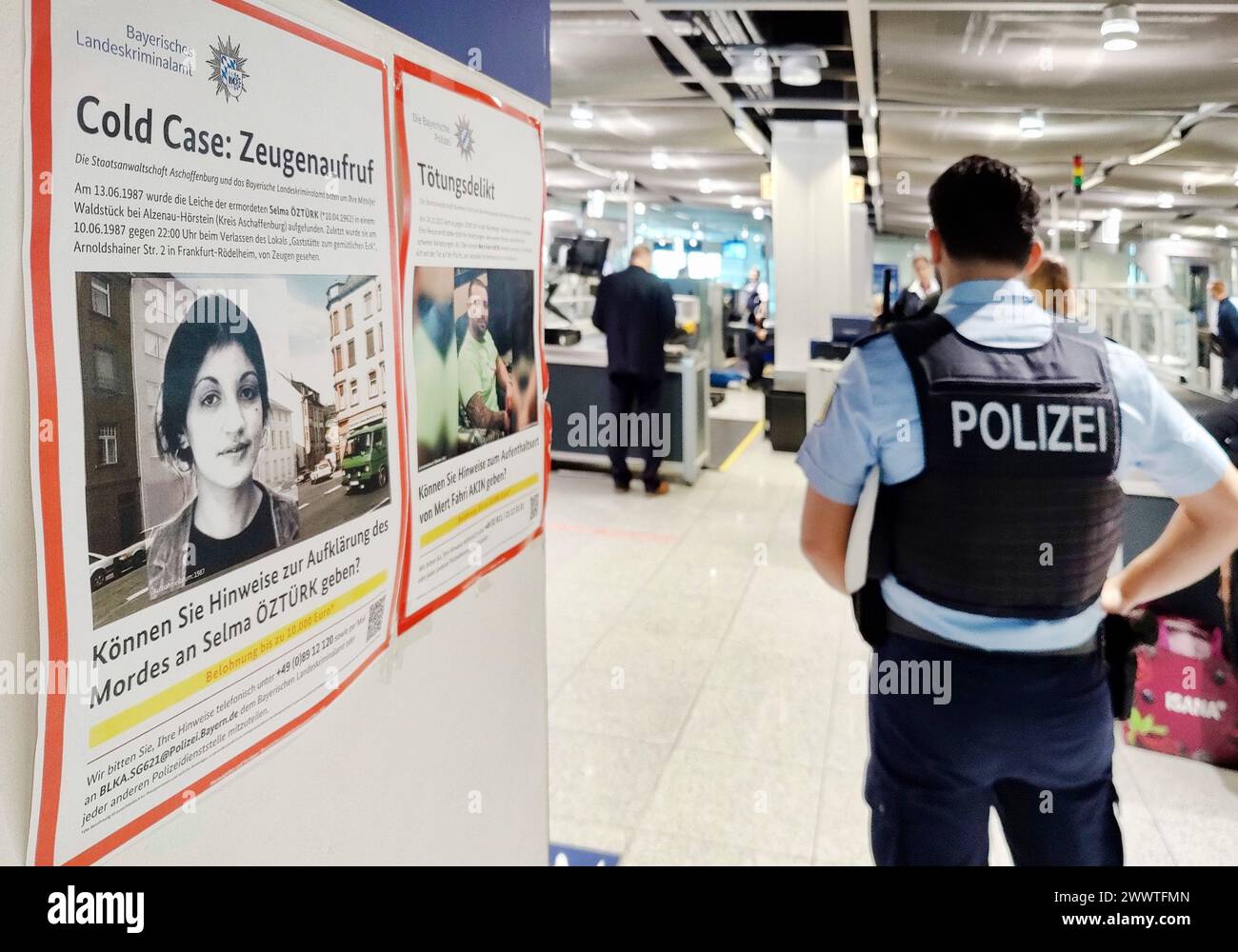 Wanted posters and police officer at Duesseldorf airport, Germany, North Rhine-Westphalia, Lower Rhine, Dusseldorf Stock Photo