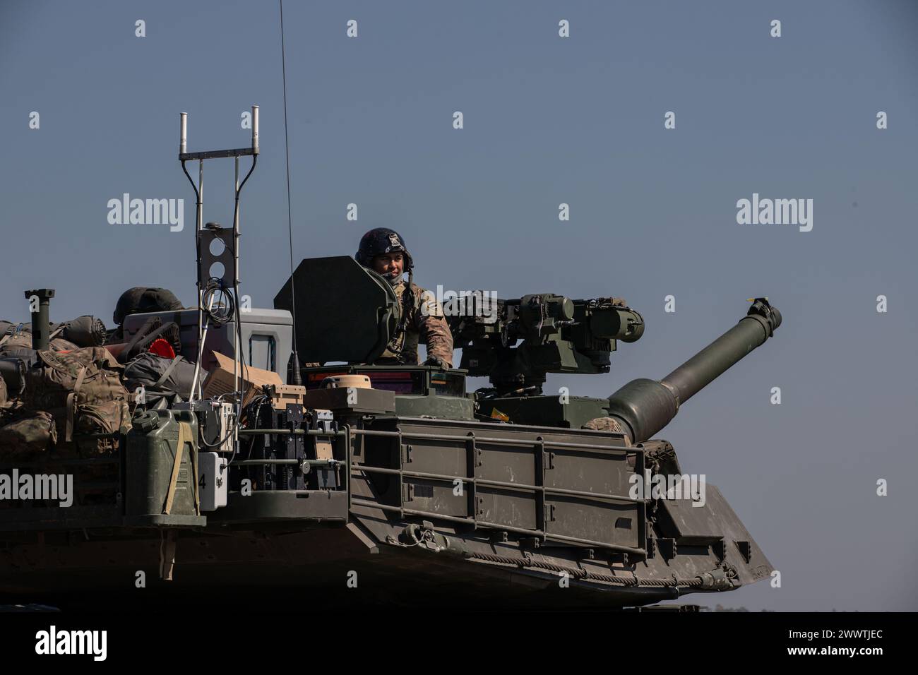 U.S. Army Staff Sgt. Vincent Espinar, a tank commander with 3rd Battalion, 67th Armored Regiment, 2nd Armored Brigade Combat Team, 3rd Infantry Division, looks out from his Abrams Tank after completing a round of the Sullivan Cup divisional assessments at Fort Stewart, Georgia, March 21, 2024. Tank commanders, primarily junior NCOs, are overall responsible for training each crewmember, ensuring proficiency in their assigned position and cross training their crewmembers in other positions. (U.S. Army photo by Sgt. Joshua Oller) Stock Photo