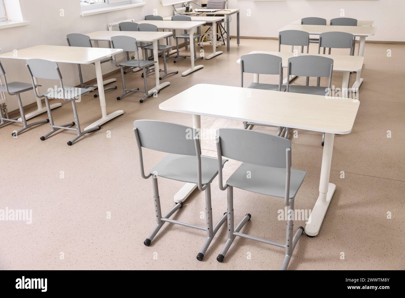 Empty school classroom with desks and chairs Stock Photo