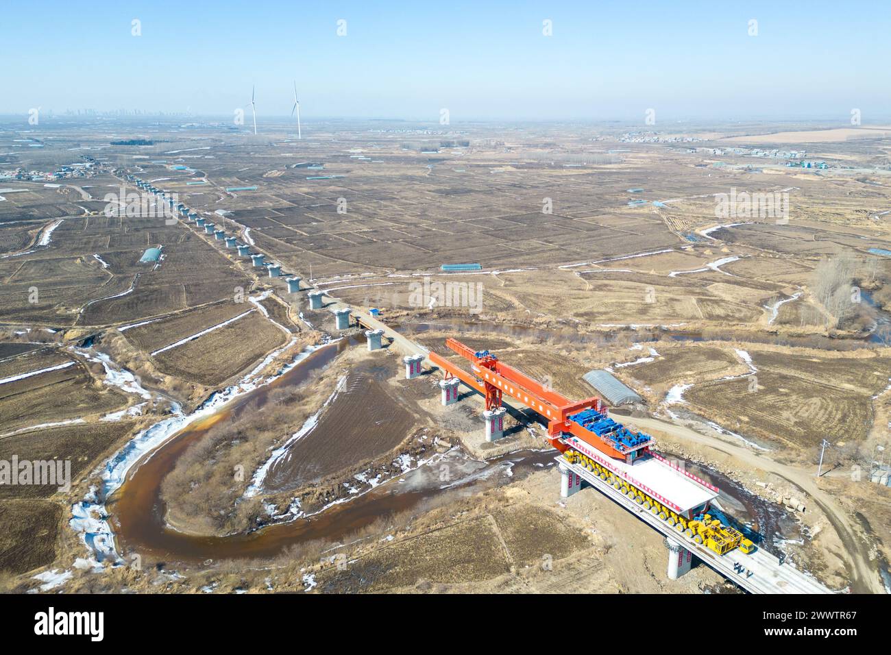 Beijing, China. 25th Mar, 2024. An aerial drone photo taken on March 25, 2024 shows the construction site of Anbanghe bridge on the Harbin-Yichun high-speed railway in northeast China's Heilongjiang Province. A 32-meter-long box girder was successfully installed on the piers of the Anbanghe bridge on Monday. Credit: Zhang Tao/Xinhua/Alamy Live News Stock Photo