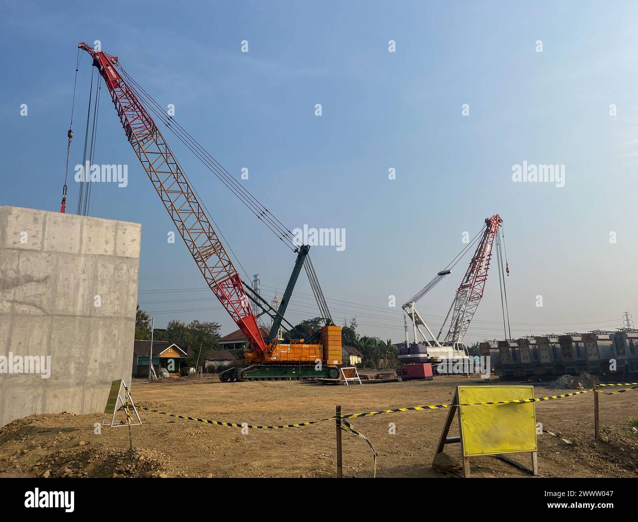 big Mobile cranes are lifting bridge trusses for transportation to be