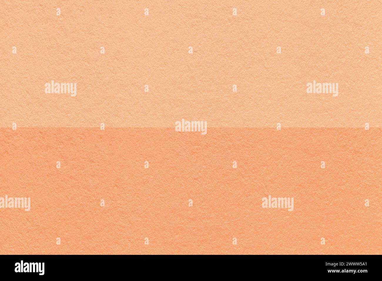 Color of the year 2024. Texture of craft peach fuzz and coral paper background, half two colors, macro. Structure of vintage dense cardboard. Felt bac Stock Photo