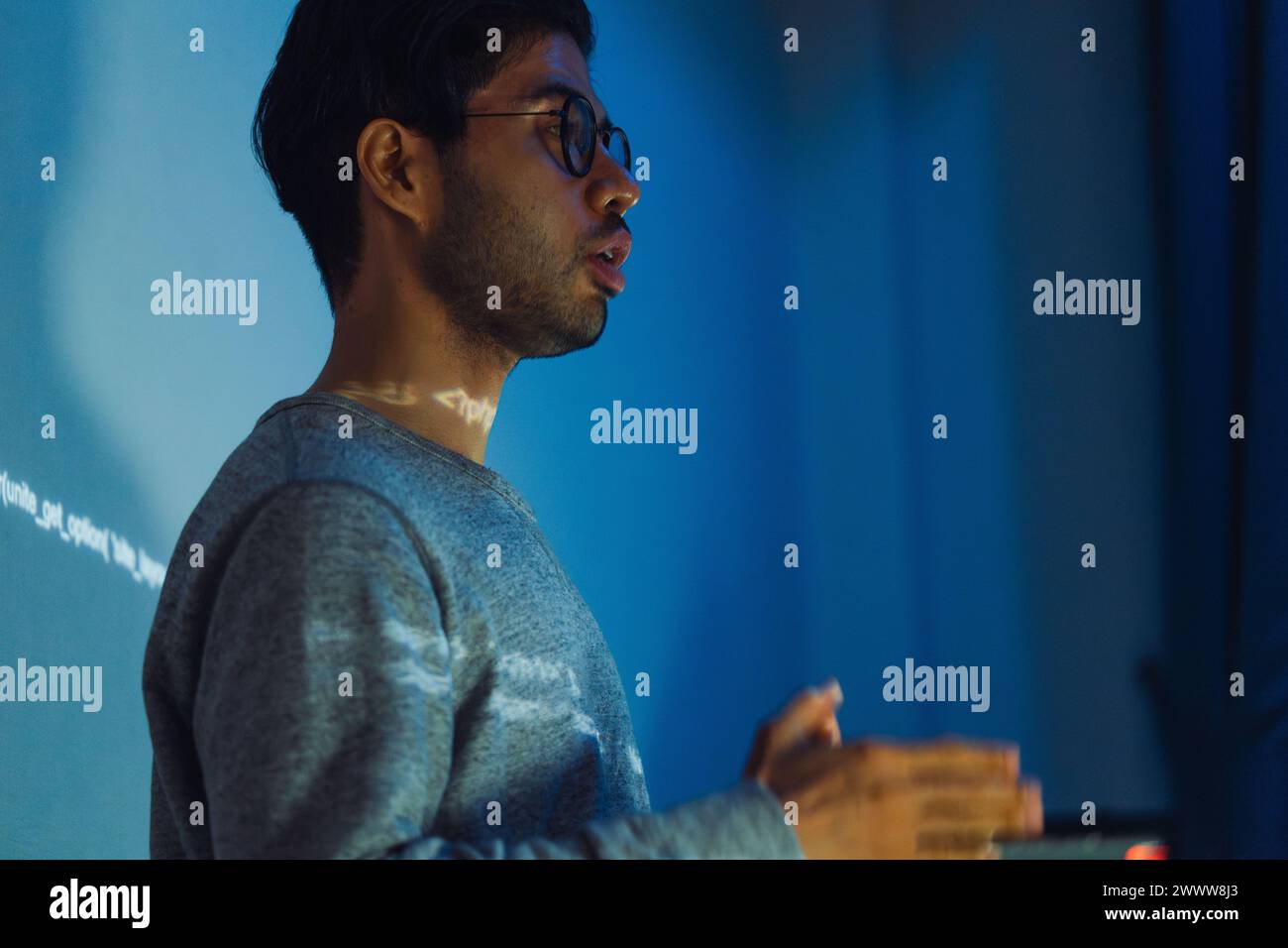 Indian man developer presentation about coding software data with devops team at night in office Stock Photo