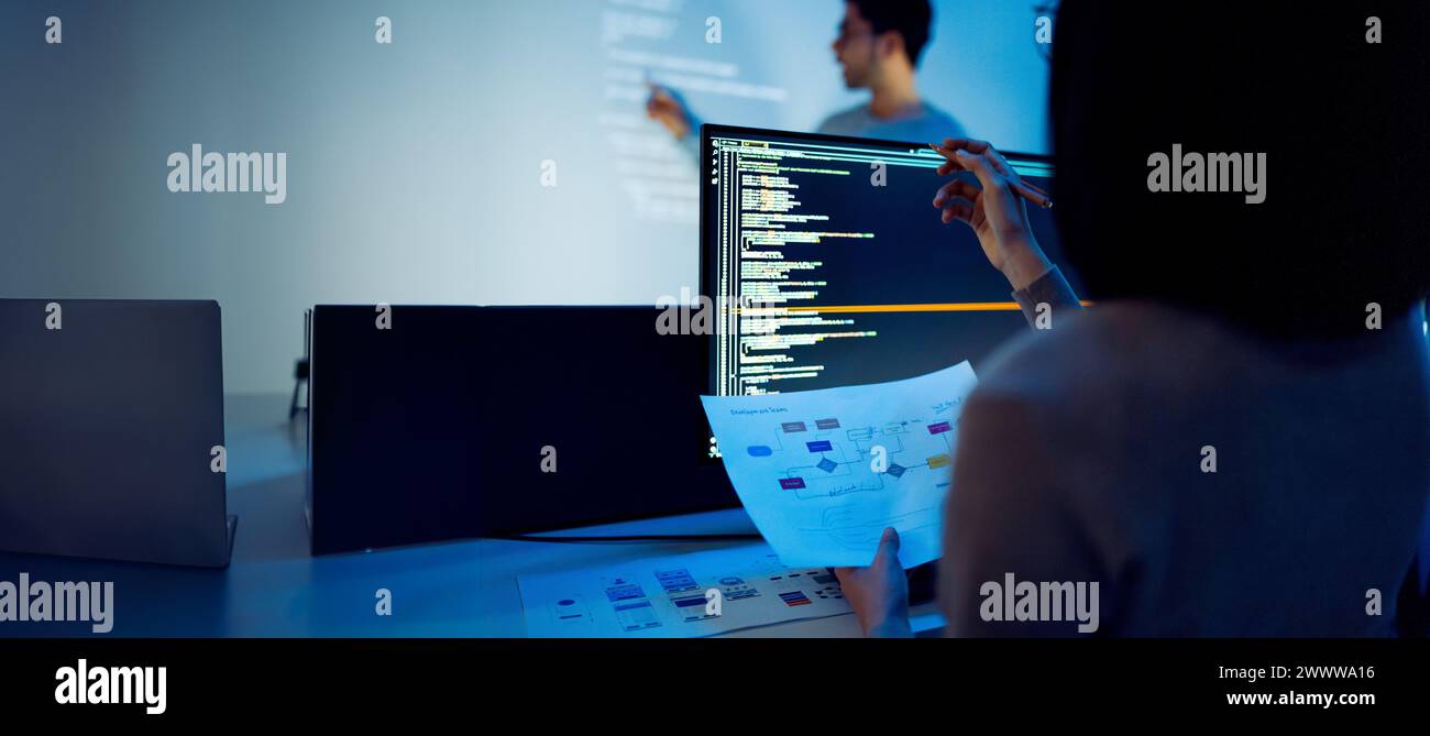 Indian man developer presentation about coding software data with devops team at night in office Stock Photo