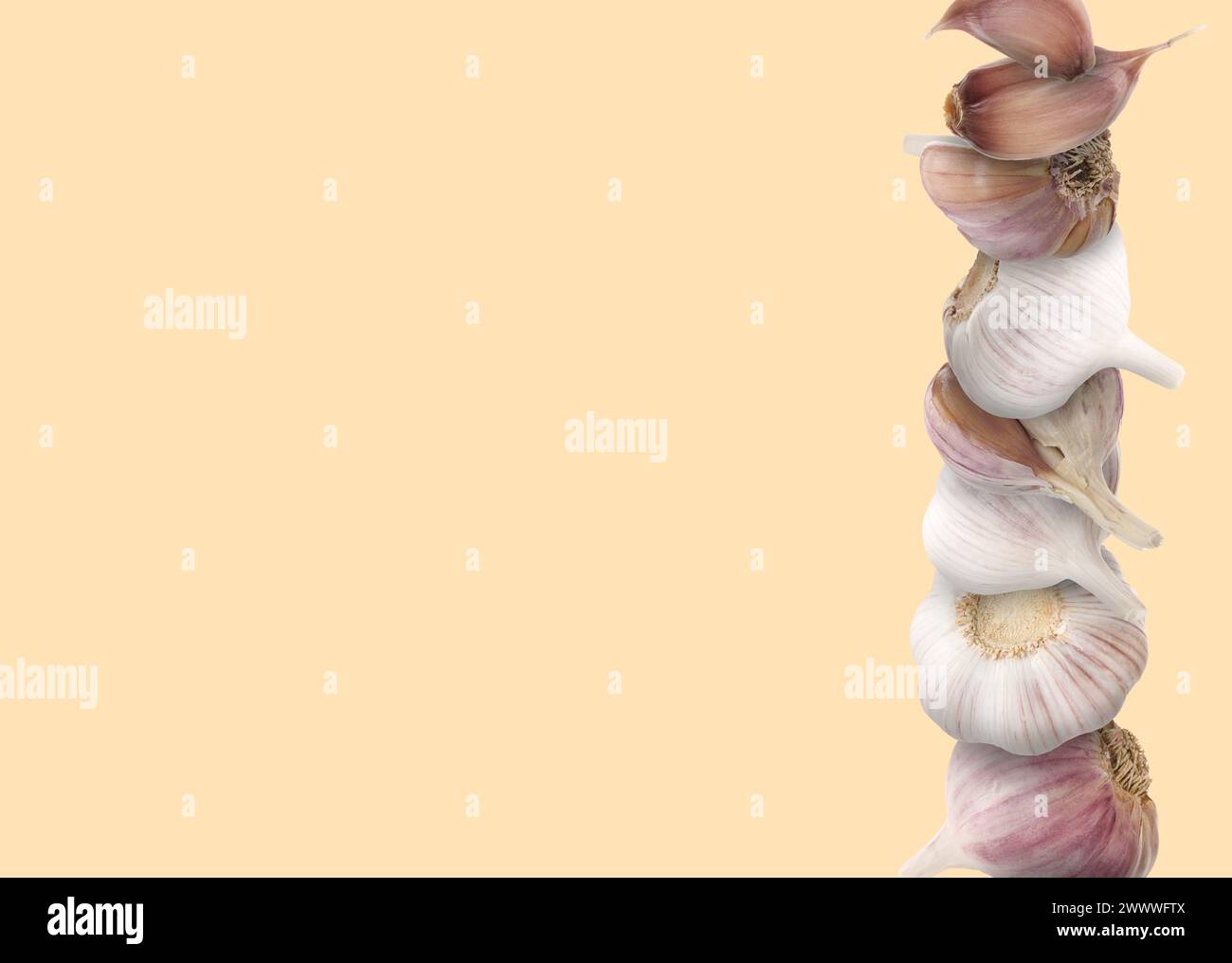 Stacked heads and cloves of garlic on beige background, space for text ...