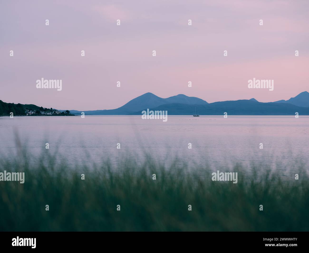 Applecross village and the distant Isle of Skye horizon view from Applecross Peninsula - dusk sea island landscape, West Highlands, Scotland UK Stock Photo