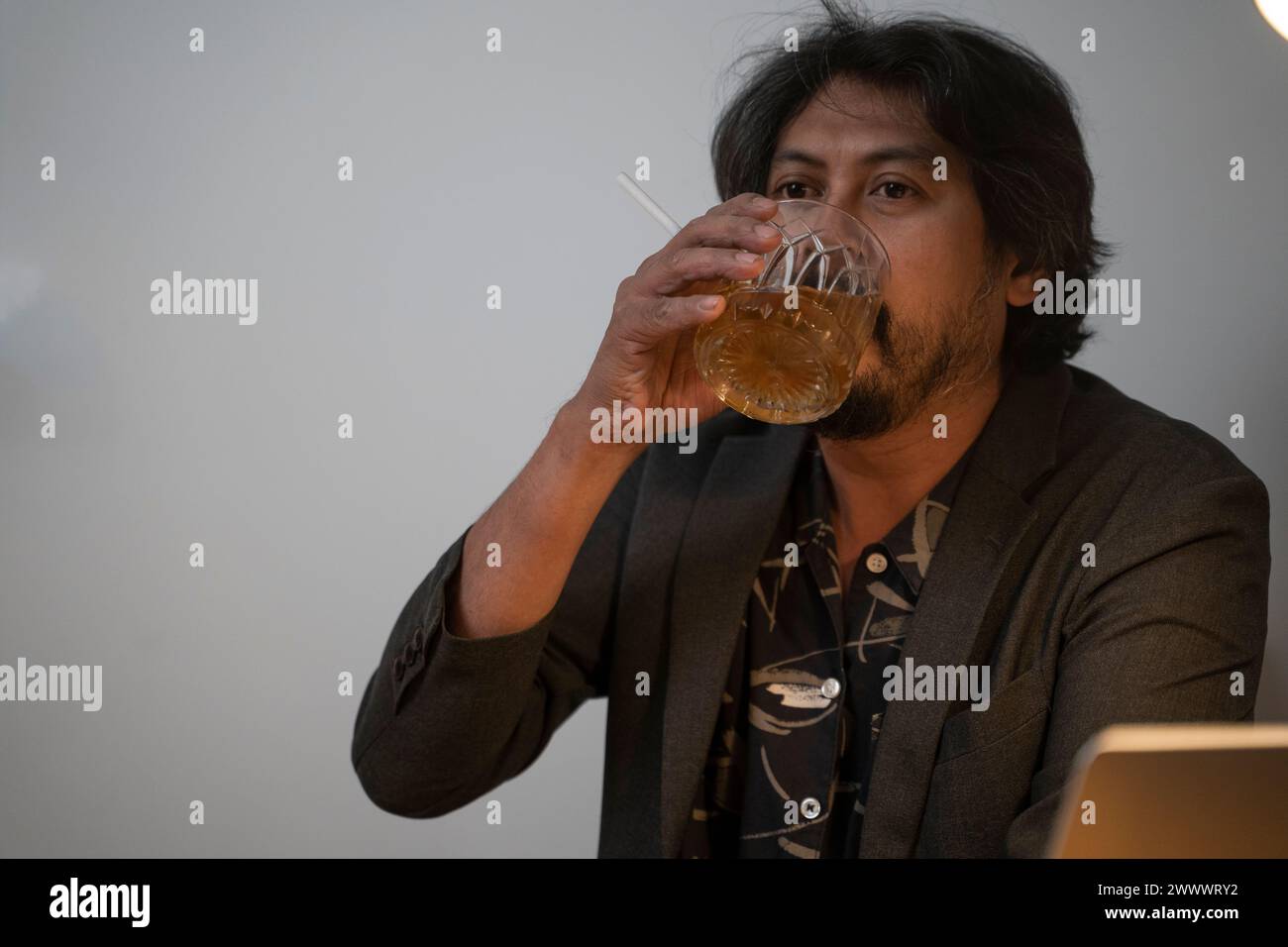 A man is tired of running an unsuccessful business by drinking. Stock Photo