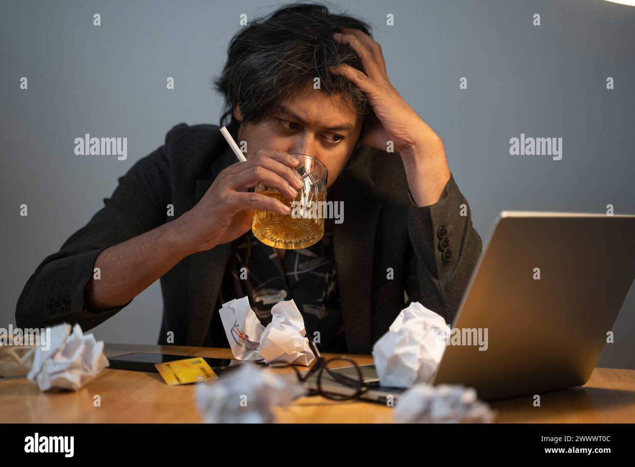 A man is tired of running an unsuccessful business by drinking. Stock Photo