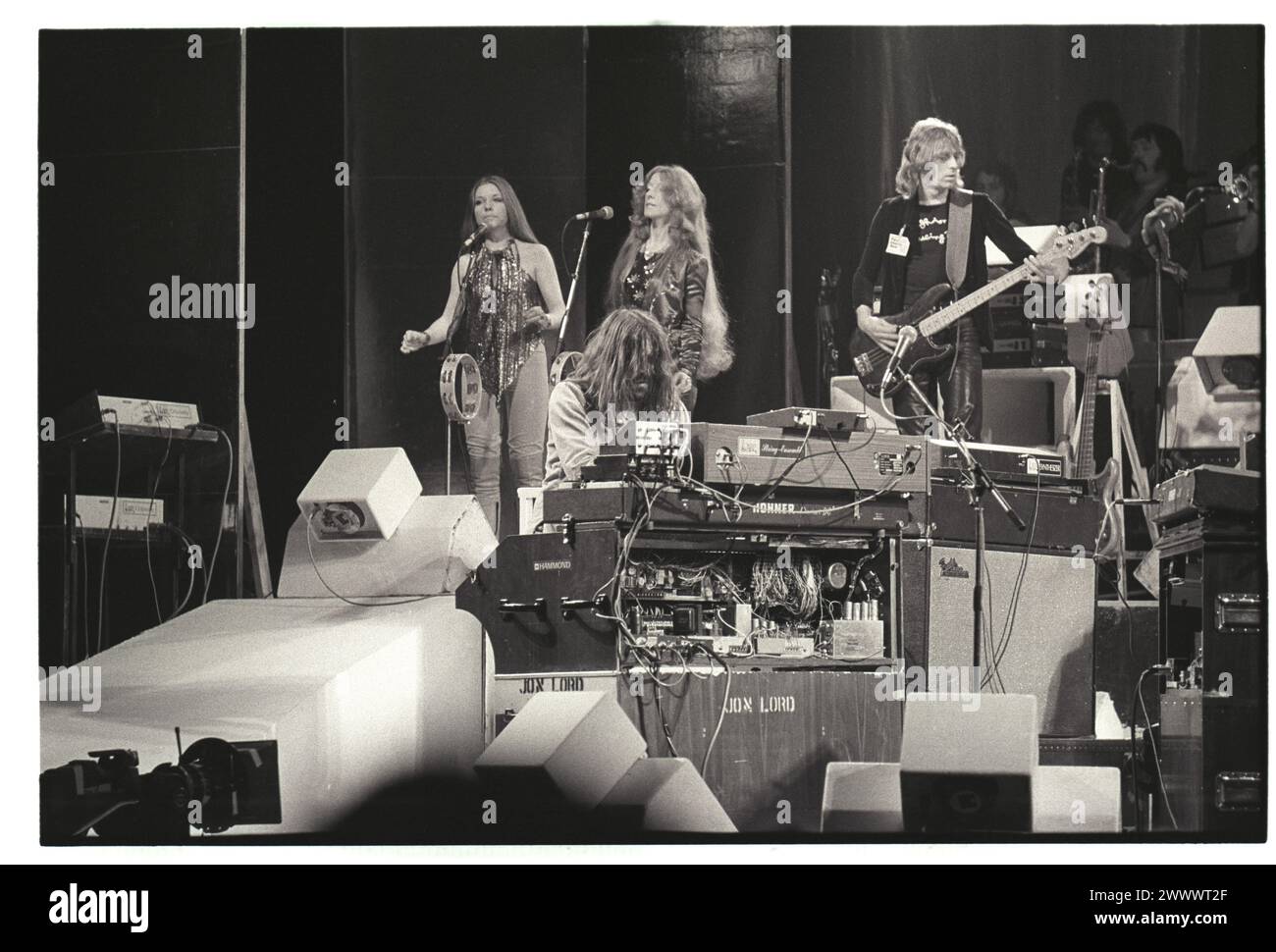 Paice Ashton Lord on stage, Birmingham, 1977. Jon Lord and bassist Paul Martinez, plus backing singers.  This was the band's only tour after Jon Lord and Ian Paice left Deep Purple the year before. It promoted their only album Malice In Wonderland but the group wasn't successful commercially and the musicians left a year later to join Whitesnake.  Photograph by Simon Robinson Stock Photo