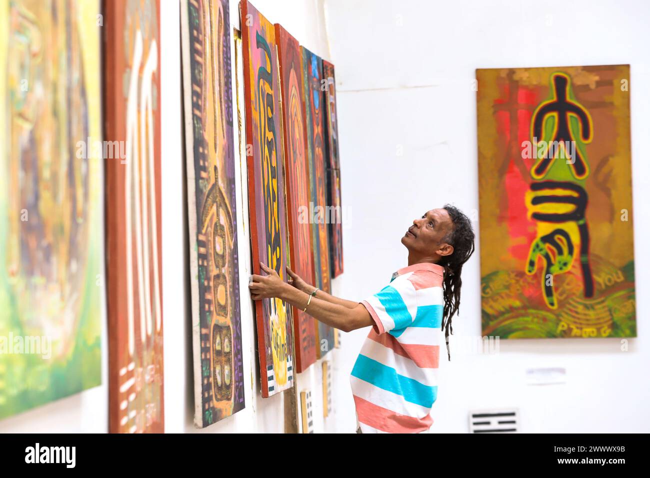 Addis Ababa, Ethiopia. 18th Mar, 2024. Artist Dawit Muluneh hangs one