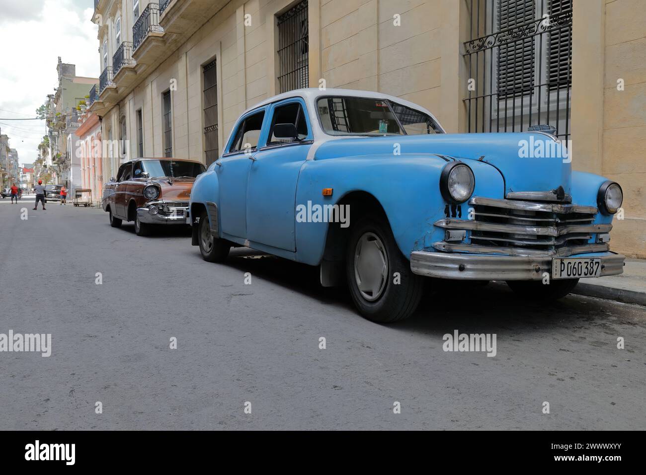 106 Blue Plymouth Special DeLuxe 1949, Chevrolet Bel Air 1957, American hard-top sedan 4-door classic cars parked on a street of Centro Havana-Cuba. Stock Photo