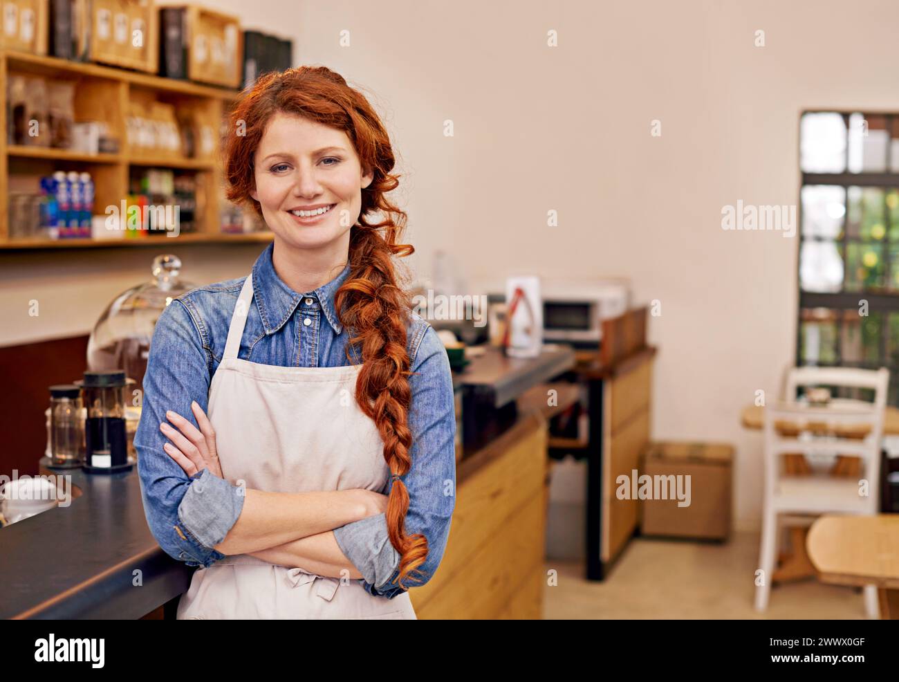 Barista, woman and arms crossed in portrait at cafe with smile, pride and entrepreneurship. Person, waitress or business owner at coffee shop with Stock Photo