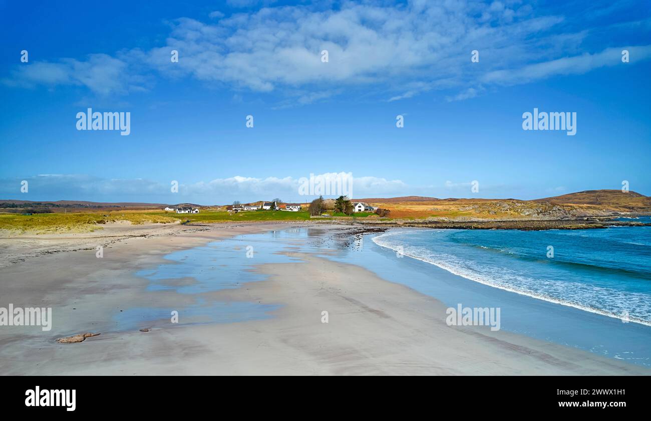 Mellon Udrigle Beach Wester Ross Scotland a blue sky over houses and a fine sandy beach and sea Stock Photo