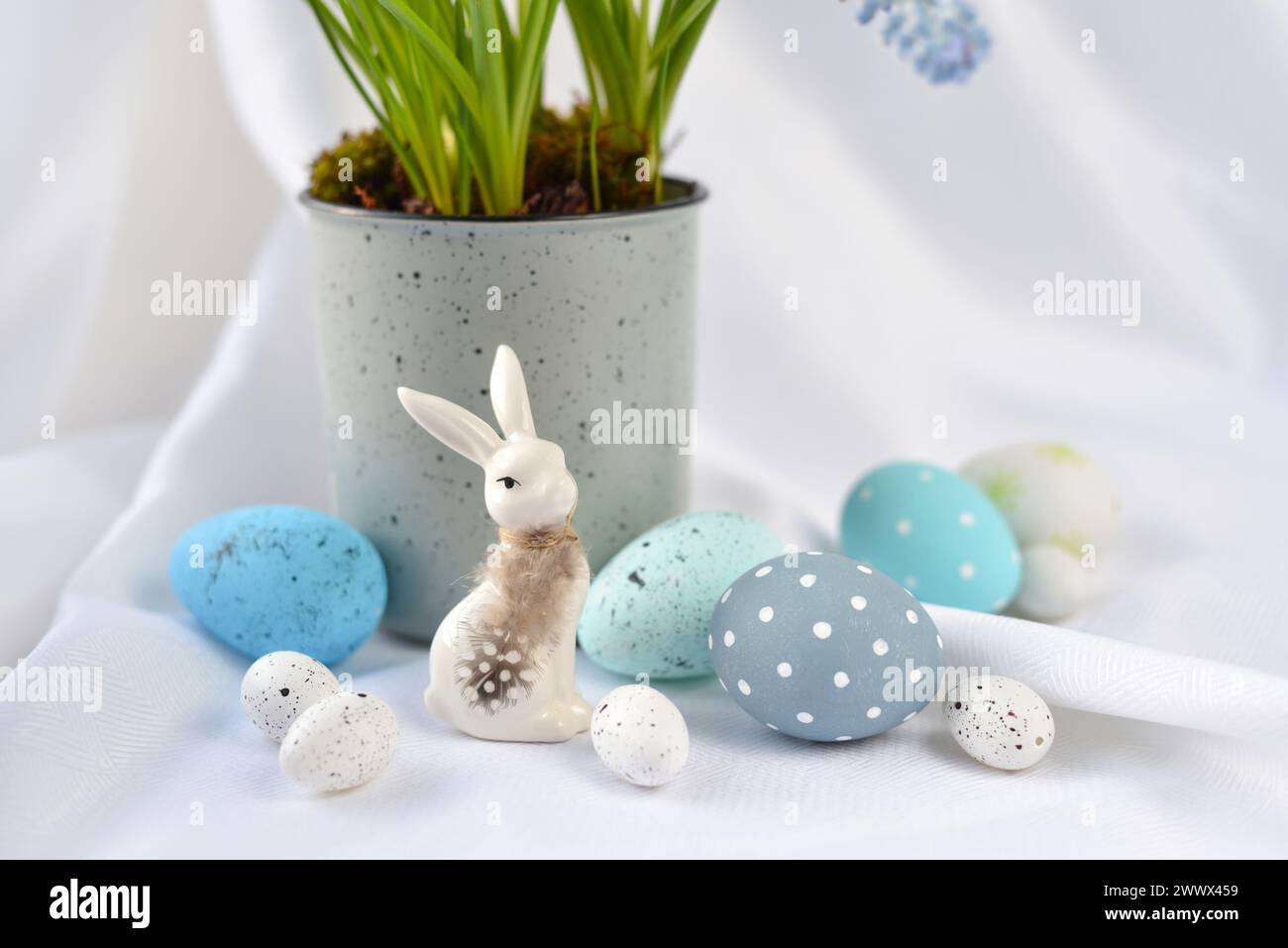 Easter composition with white rabbit and eggs on a white background. The minimal concept. Stock Photo