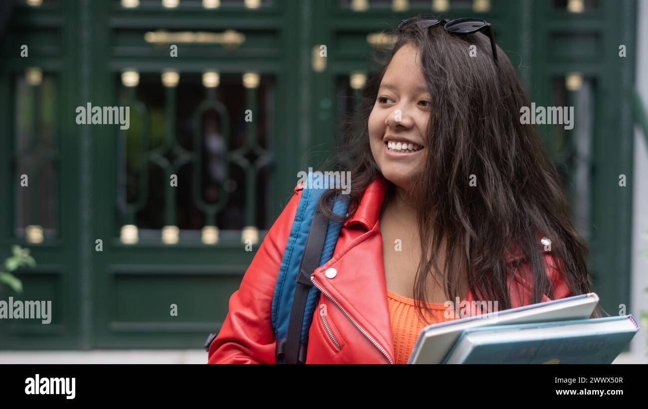happy young student walking with books and bag Stock Photo