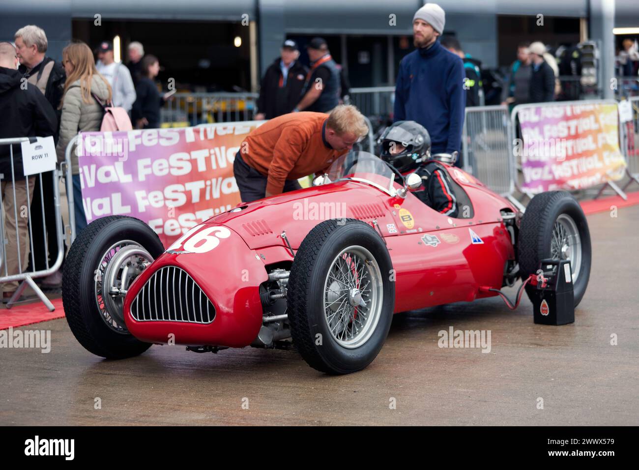 Julia De Baldanza, in her Red, Alta Grand Prix car, in the International paddock, before the start of the HGPCA pre '66 Grand prix Cars Race. Stock Photo