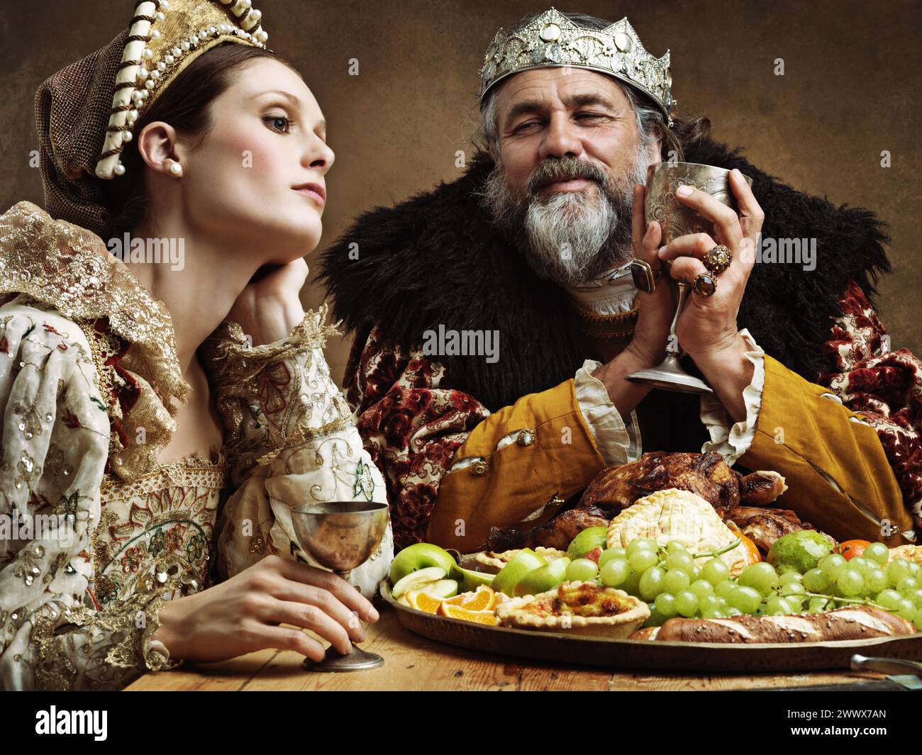 King, queen and feast with wine at table for fine dinning in royal ...