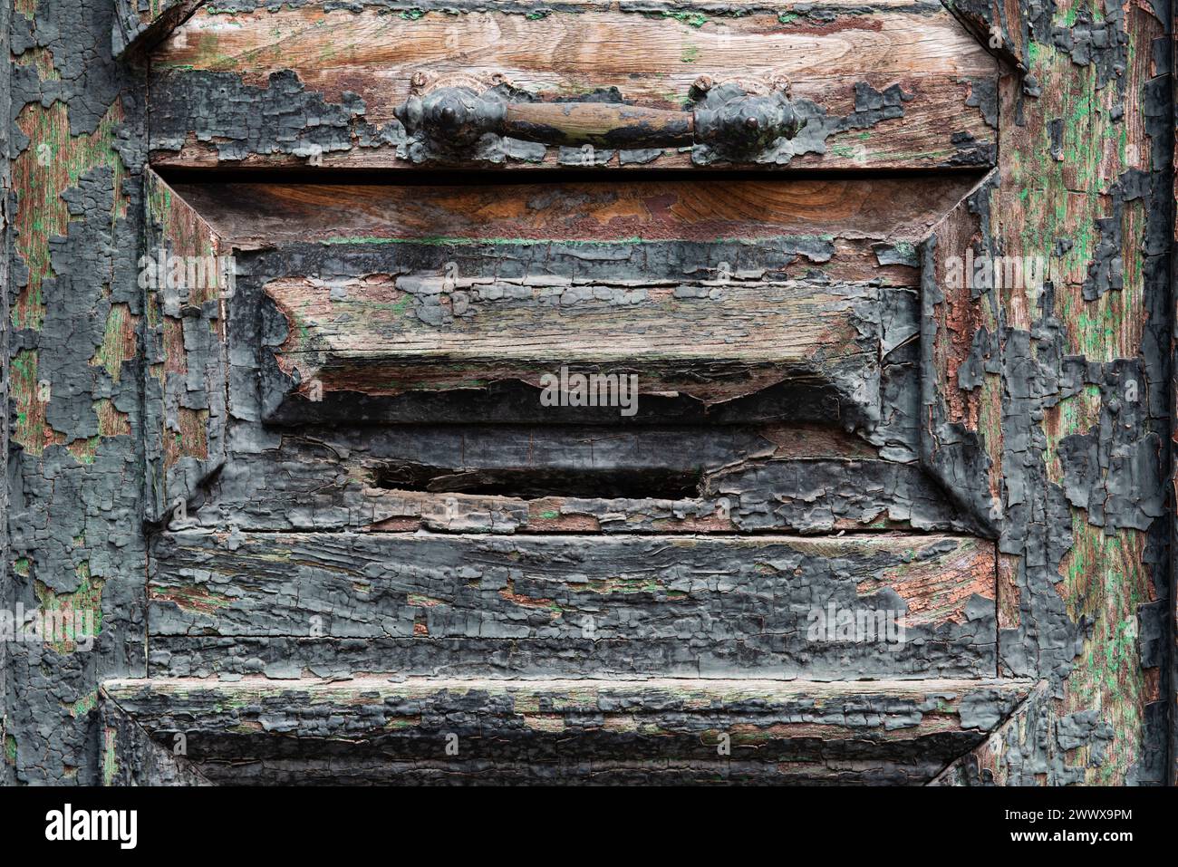 Abstract detail of a colorful, cracked and peeling wooden doorway in the Old Town historic neighborhood of Tbilisi, capital of the Republic of Georgia Stock Photo