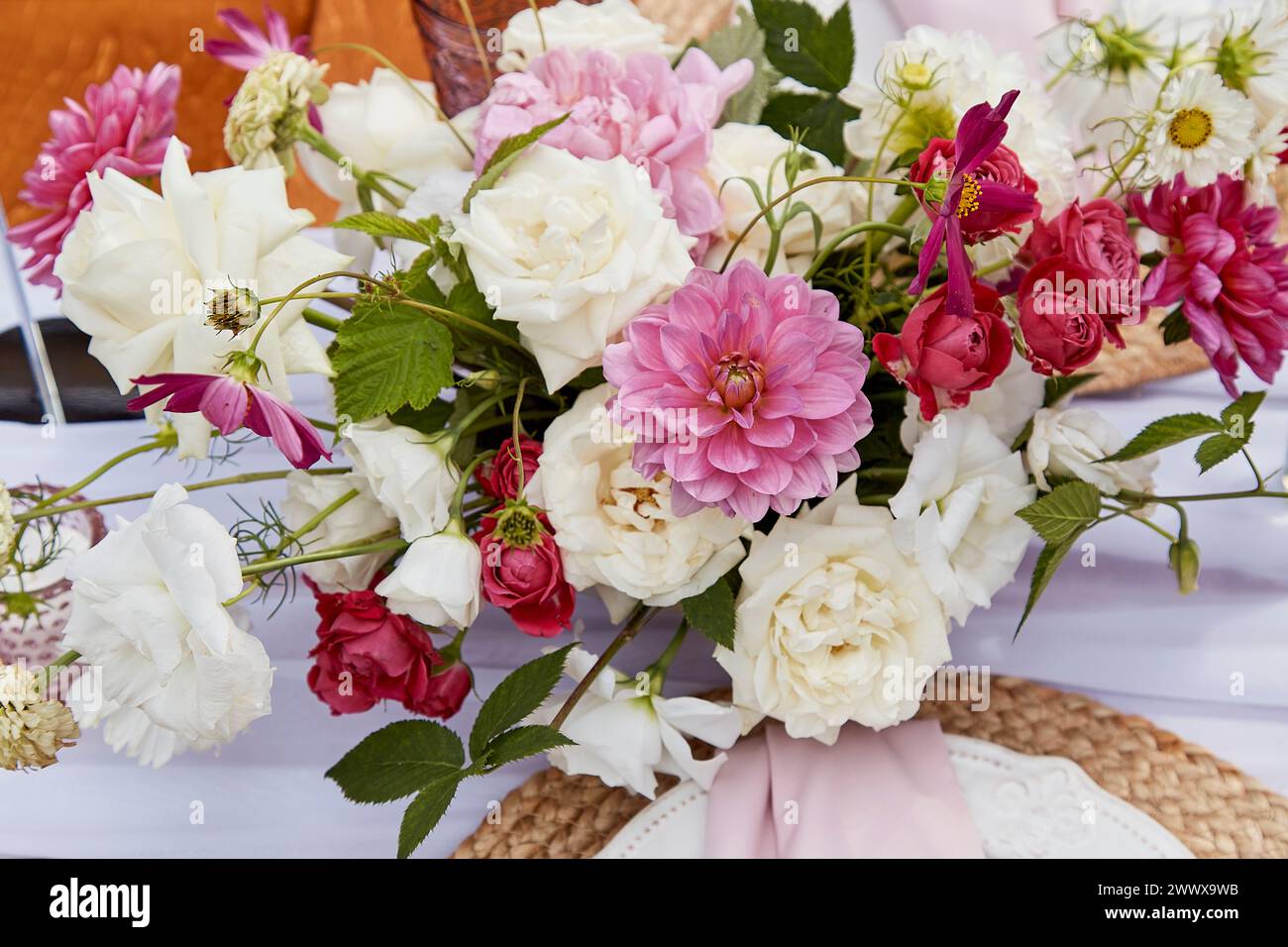Vibrant bouquet with mix of pink dahlias and white roses. Floral design inspiration and botanical art. Stock Photo