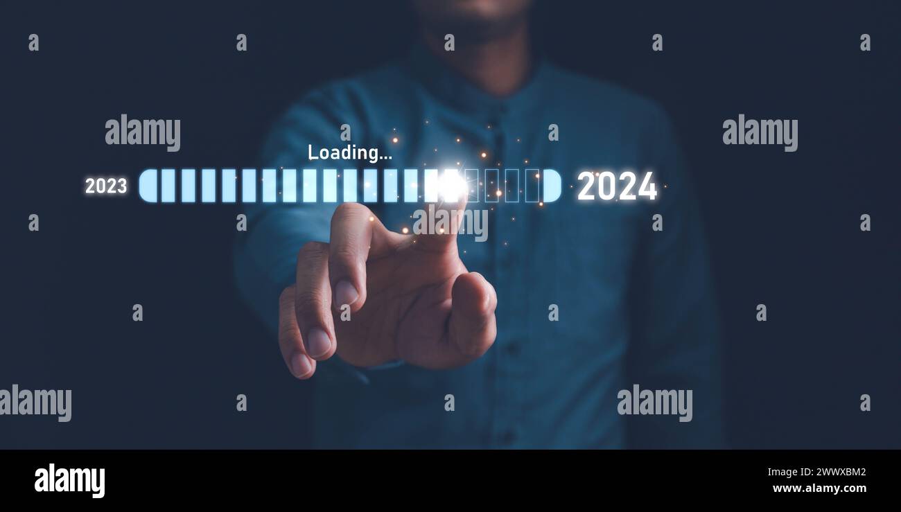 Businessman touch on loading progress from 2023 to 2024,Planning and challenge strategy in new year 2024 Concept. New business startup in 2024. New ye Stock Photo