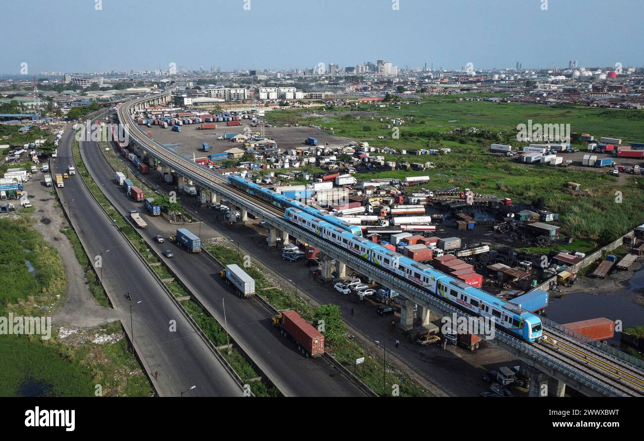 (240326) -- LAGOS, March 26, 2024 (Xinhua) -- An aerial drone photo taken on March 4, 2024 shows trains running on the Lagos Rail Mass Transit (LRMT) Blue Line in Lagos, Nigeria. Undertaken by China Civil Engineering Construction Corporation (CCECC) in July 2010 and completed in Dec. 2022, the first phase of the Lagos Rail Mass Transit (LRMT) Blue Line corridor spans 13 km and covers five stations. It began commercial operation in Sept. of 2023. As a symbolic project of the Belt and Road Initiative, the Blue Line project is the first electrified railroad and cross-sea light rail project in Wes Stock Photo