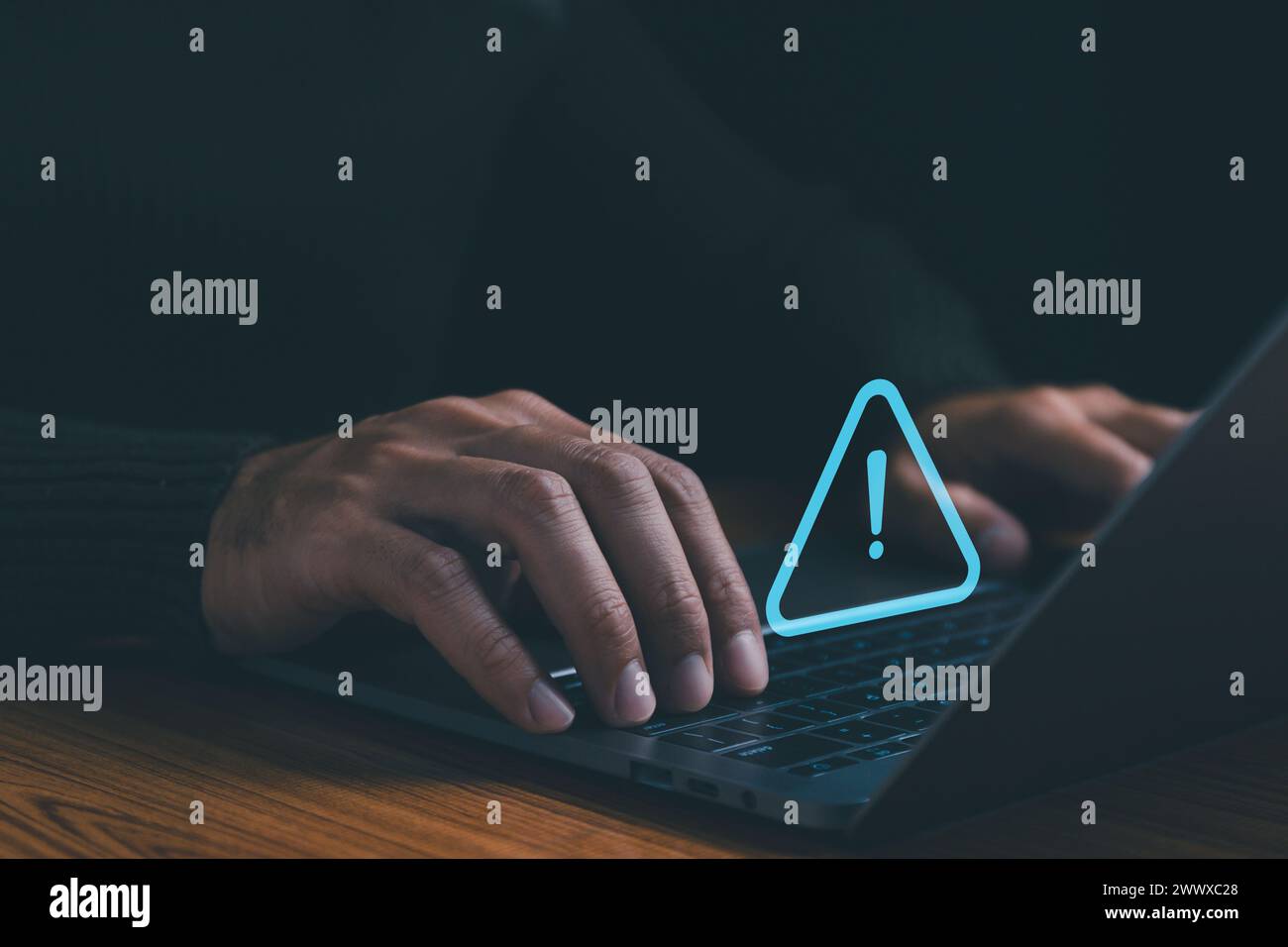 Businessman using laptop computer with alerts, warning triangles ...