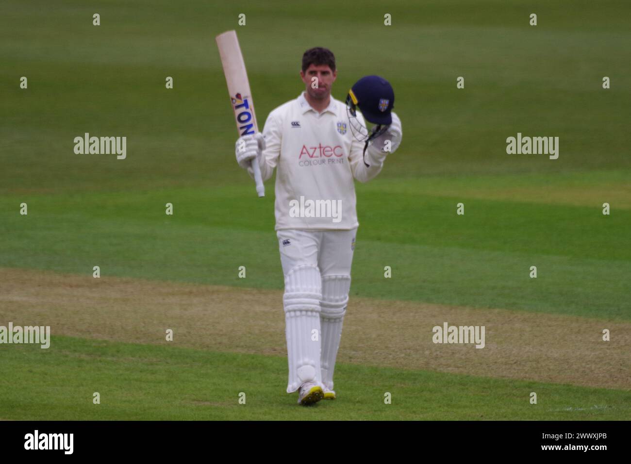 Chester le Street, 26 March 2024. Colin Ackermann raising his bat on reaching his century for Durham Cricket against Durham UCCE in a pre season match. Credit: Colin Edwards/Alamy Live News Stock Photo