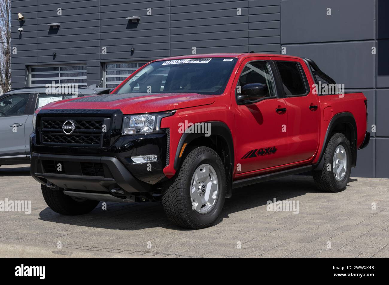 Indianapolis - March 24, 2024: Nissan Frontier SV Crew Cab display. Nissan offers the Frontier in S, SV, PRO-X, PRO-4X, and Midnight Edition. MY:2024 Stock Photo